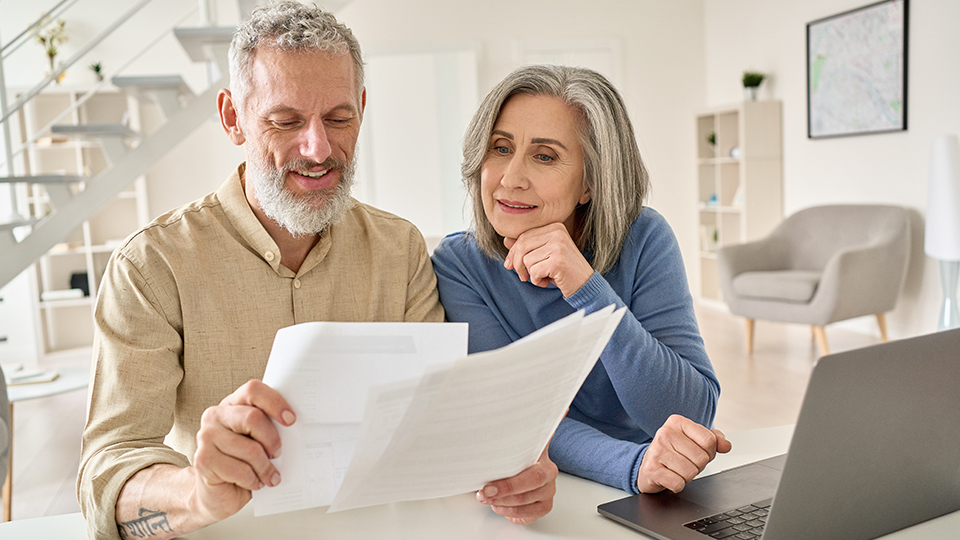 An older couple reviewing their estate planning papers at home