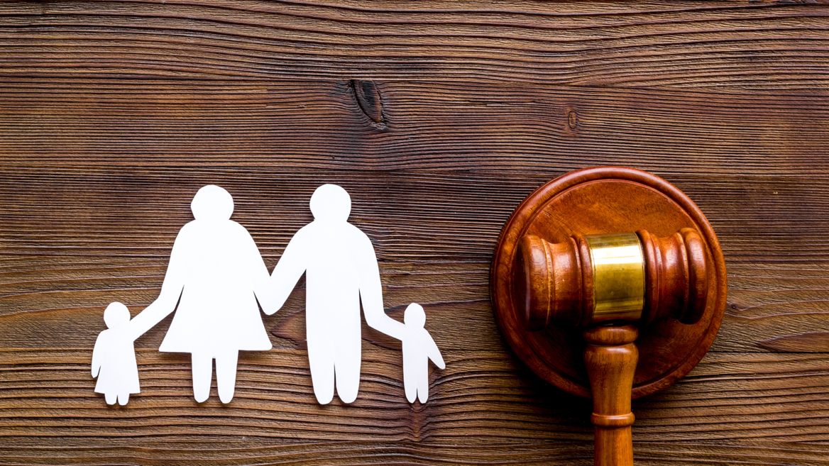 A paper cutout of a family beside a judge’s gavel, representing family law cases